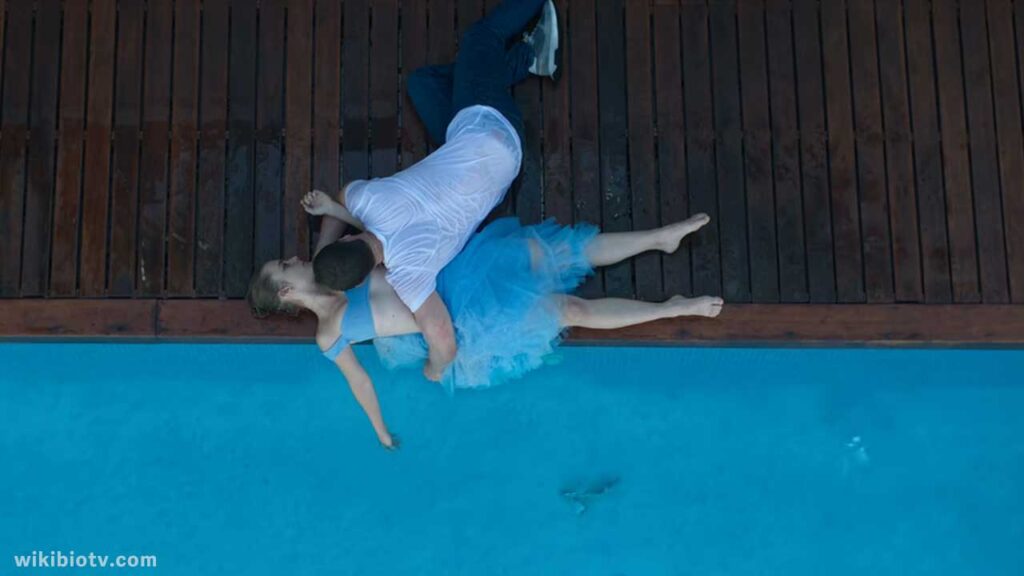 The Movie still where Ares saves Raquel from drowning in Pool water