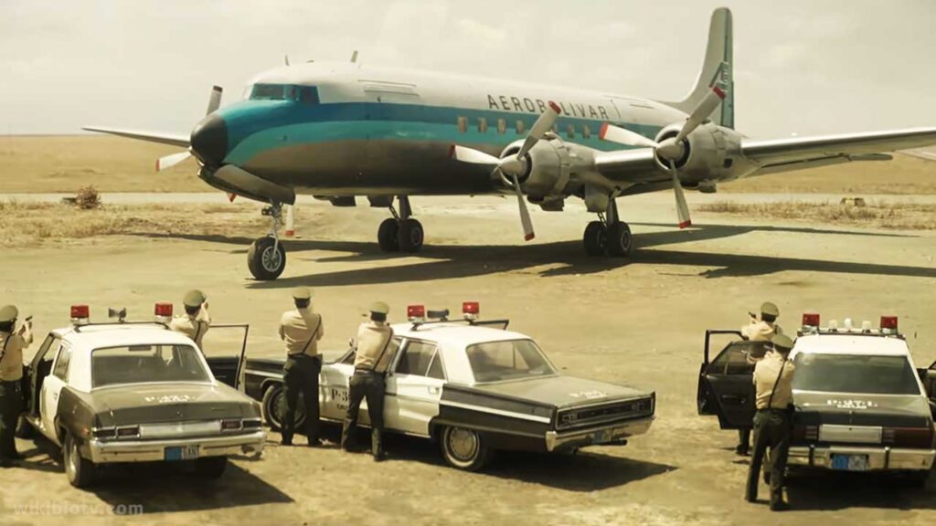 The scene where plane is surrounded by police and guns